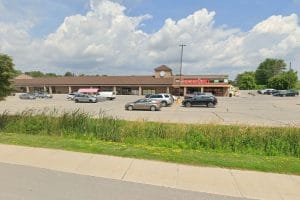 Exterior view of Beeton Foodland grocery store with parking lot and cars, where Beeton Fall Fair advance passes are sold